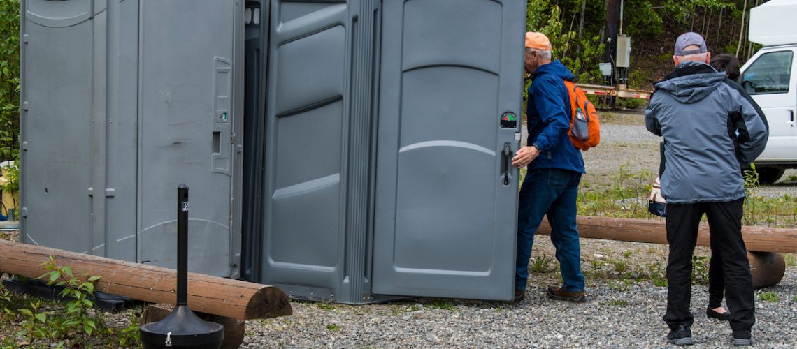 Man entering portable bathroom